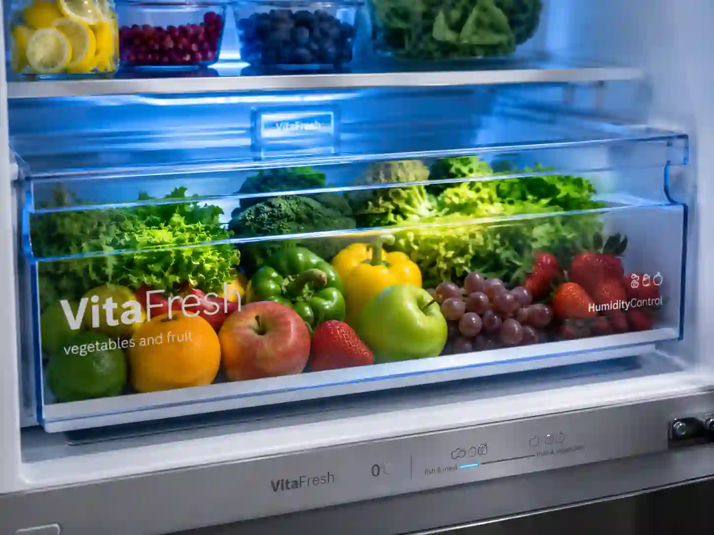 Bosch VitaFresh drawer inside 335L refrigerator storing fresh fruits and vegetables with humidity control and cooling technology.